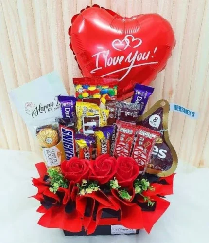 Best Of Love gift box with mixed chocolates, Hershey's Kisses, M&M's, fresh roses, and Love You balloon.