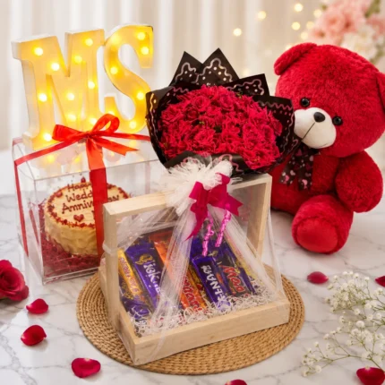 Forever Love Anniversary Hamper with red velvet cake, 4 dozen red roses, teddy bear, chocolates, balloons, and luxury wooden gift basket in Karachi.