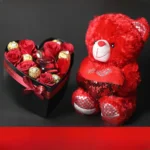 Sweet Teddy & Ferrero Rose Box with teddy bear, fresh red roses, Ferrero Rocher chocolates, and heart-shaped romantic gift box.